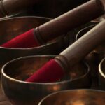 a close up of many metal bowls with wooden handles